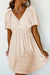 Textured beige mini jurk met diepe v-hals voor stijlvolle dames
